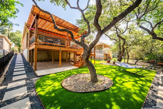 rear view of property featuring a lawn and a wooden deck