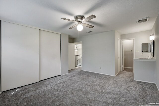 spare room featuring carpet floors and ceiling fan