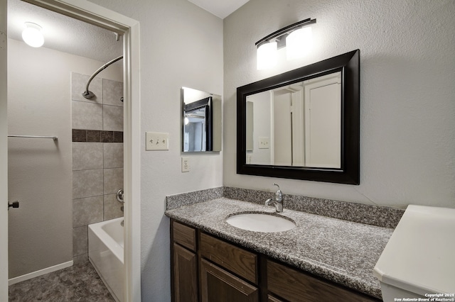 full bathroom with a textured ceiling, vanity, and bathing tub / shower combination