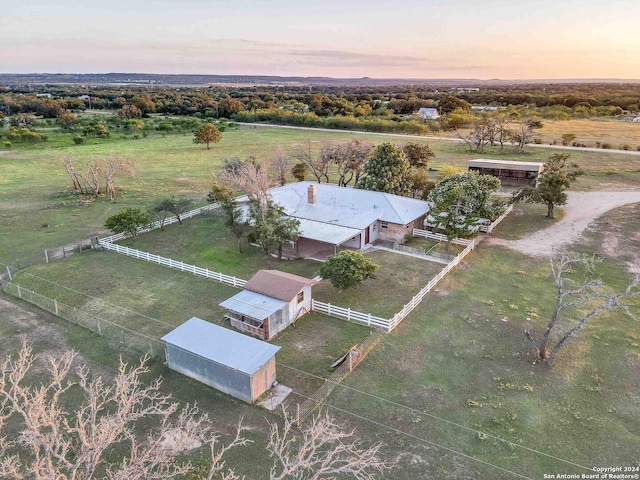 aerial view at dusk featuring a rural view