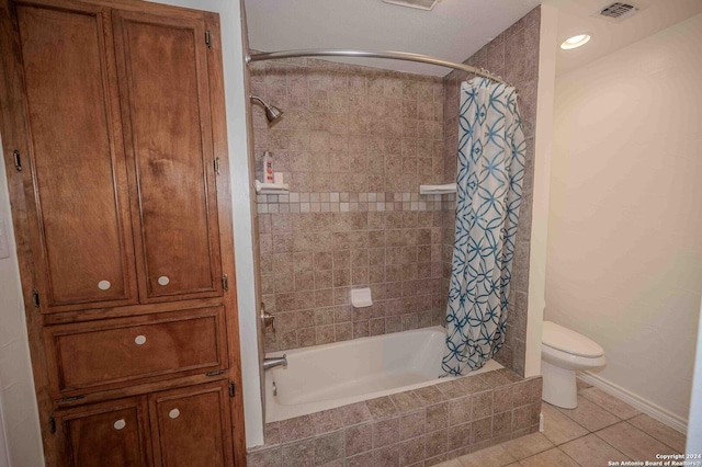 bathroom with toilet, tile patterned floors, and shower / tub combo with curtain