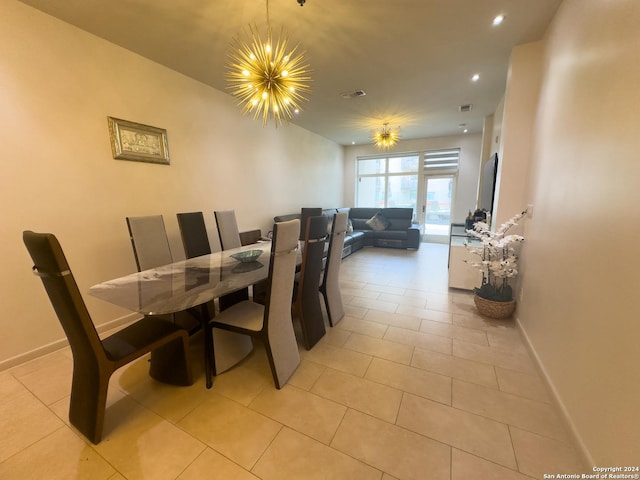 dining room featuring light tile patterned flooring and a chandelier