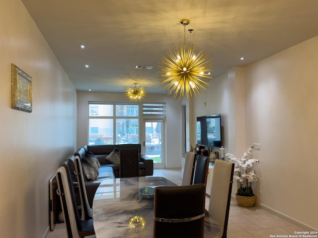 tiled dining room featuring an inviting chandelier