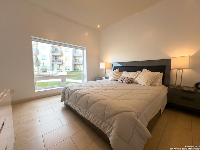 bedroom featuring lofted ceiling and light tile patterned floors