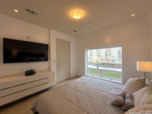 bedroom with light tile patterned floors