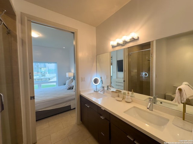 bathroom featuring tile patterned floors, vanity, and walk in shower