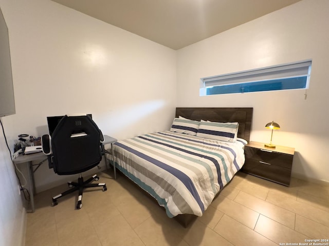 bedroom with light tile patterned floors