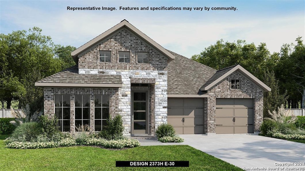 view of front of home with a garage and a front lawn