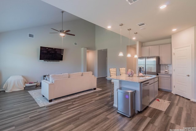 kitchen featuring appliances with stainless steel finishes, dark hardwood / wood-style flooring, a kitchen island with sink, high vaulted ceiling, and gray cabinets