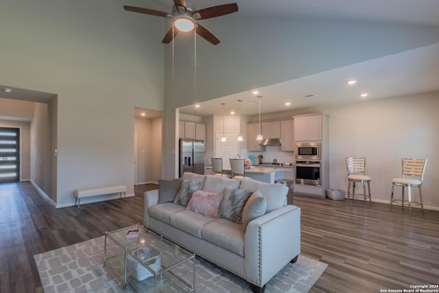 living room featuring ceiling fan, high vaulted ceiling, and dark wood-type flooring