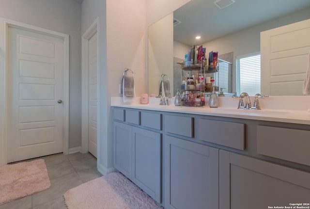 bathroom with tile patterned flooring, vanity, and a shower with shower door