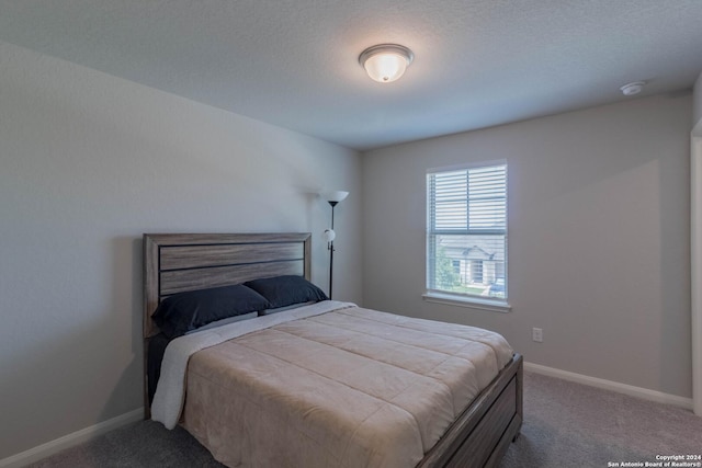 carpeted bedroom featuring a textured ceiling