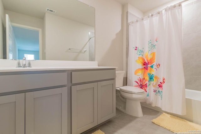 full bathroom with tile patterned flooring, vanity, toilet, and shower / bath combo with shower curtain