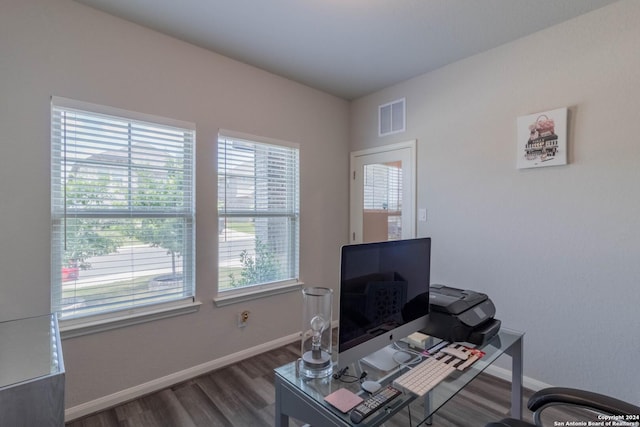 home office with dark hardwood / wood-style floors