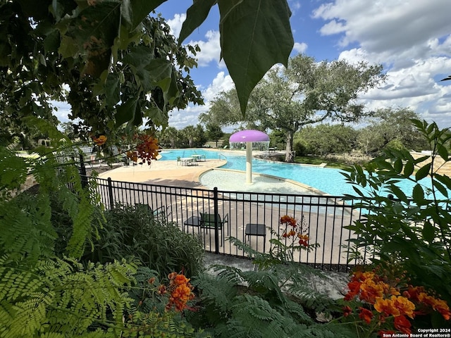 view of pool featuring a patio and pool water feature