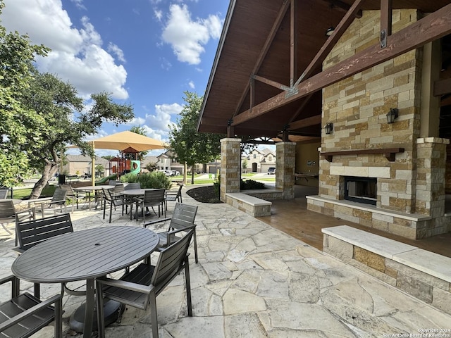 view of patio / terrace featuring an outdoor stone fireplace