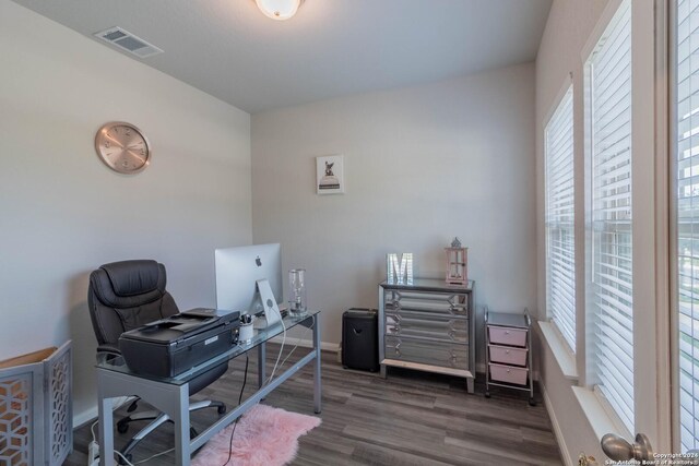 office space with dark hardwood / wood-style flooring and a wealth of natural light