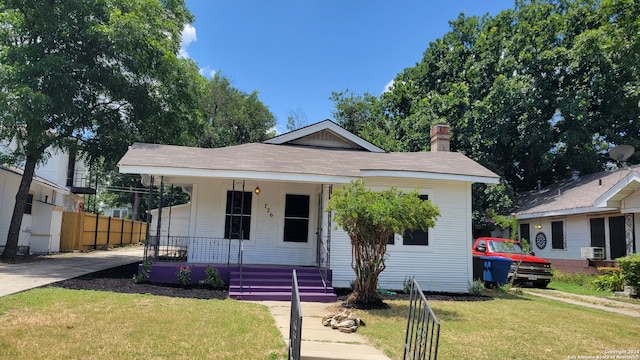 bungalow featuring a porch and a front yard