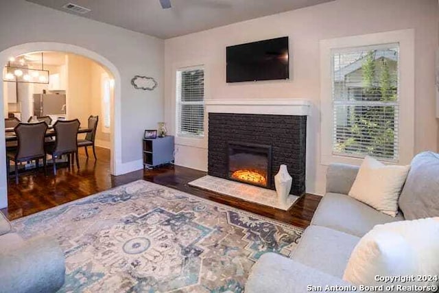 living room with ceiling fan and dark hardwood / wood-style floors