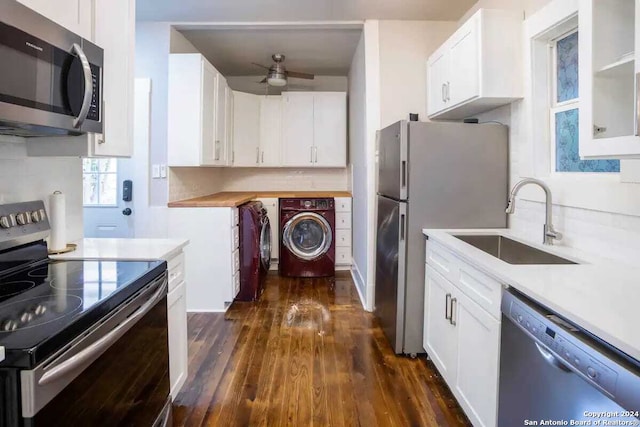 kitchen with sink, appliances with stainless steel finishes, white cabinetry, dark hardwood / wood-style floors, and washer / dryer