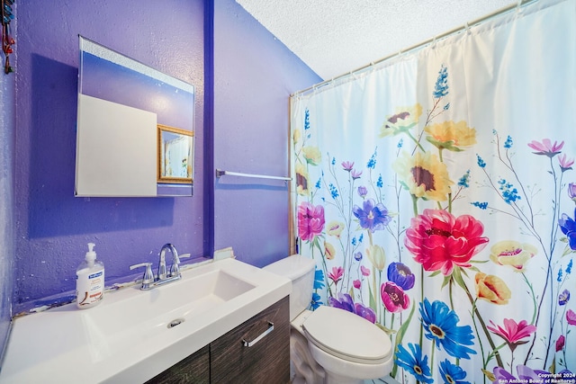 bathroom with a shower with shower curtain, vanity, toilet, and a textured ceiling