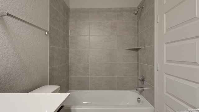 full bathroom featuring vanity, toilet, and tiled shower / bath