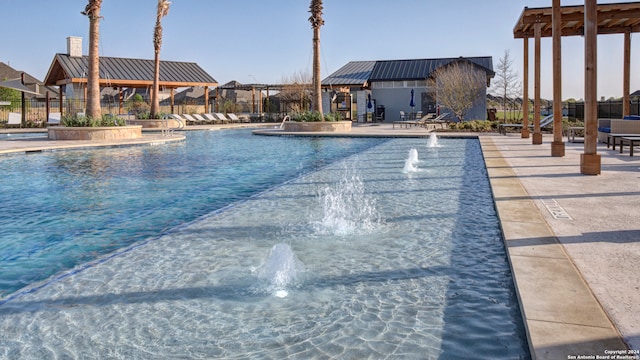 view of pool with a gazebo, pool water feature, and a patio