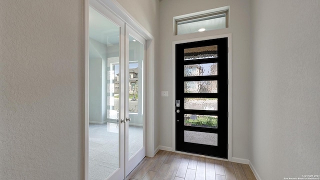 foyer featuring french doors and light wood-type flooring