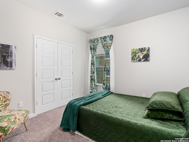 carpeted bedroom featuring a closet