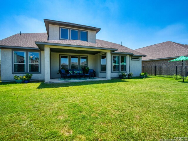 back of house featuring a patio, an outdoor hangout area, and a yard