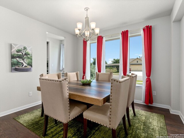 dining room with a notable chandelier and dark hardwood / wood-style floors