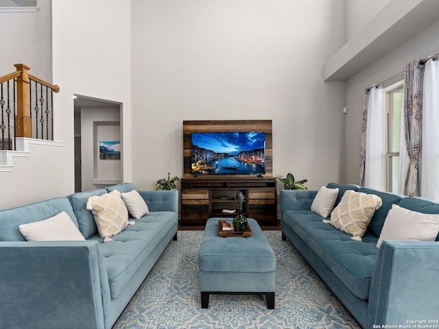 living room featuring a towering ceiling