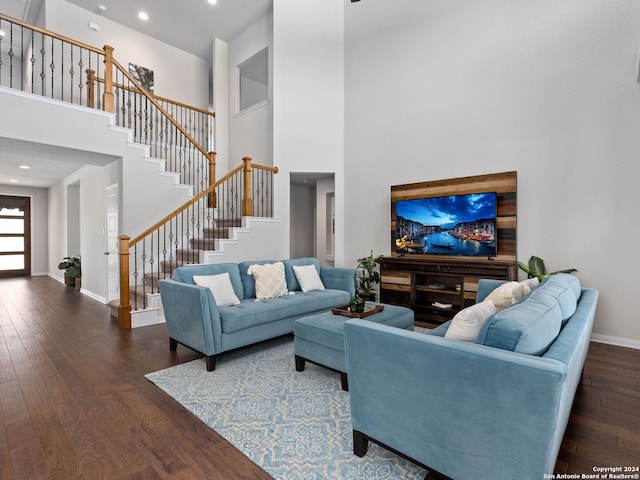 living room with a high ceiling and hardwood / wood-style floors