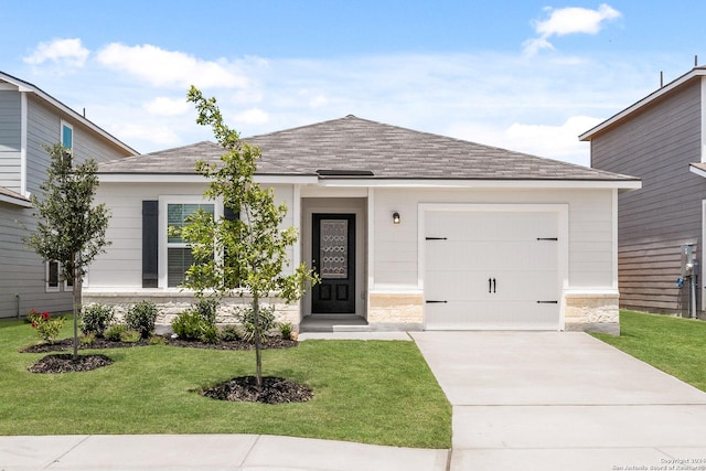 view of front of home featuring a garage and a front lawn