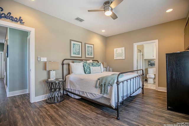 bedroom featuring dark hardwood / wood-style flooring, ensuite bath, and ceiling fan