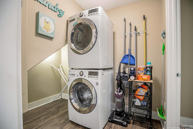 washroom featuring stacked washer / drying machine and dark hardwood / wood-style floors