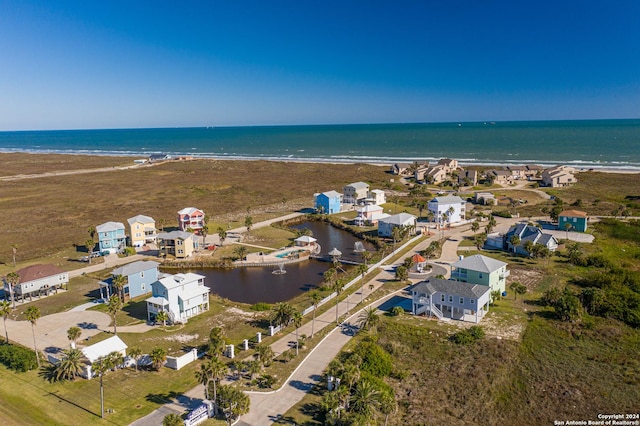 drone / aerial view featuring a view of the beach and a water view