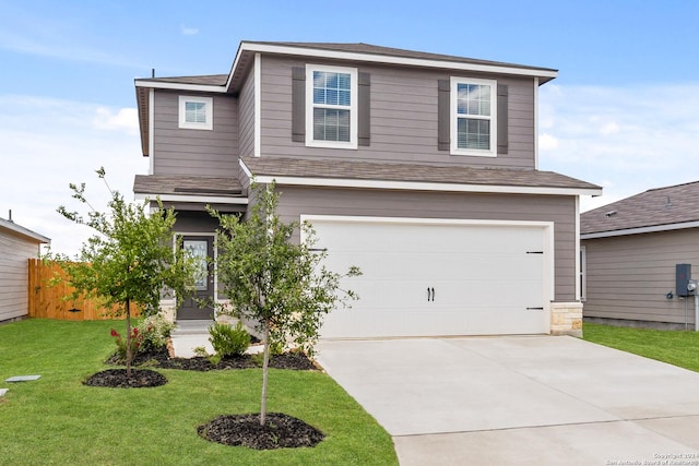 view of front of house with a garage and a front yard