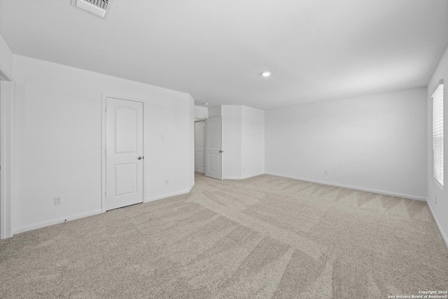 unfurnished room with light carpet