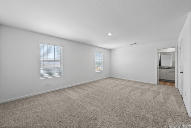 empty room with light colored carpet