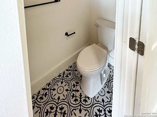 bathroom with toilet and tile patterned floors