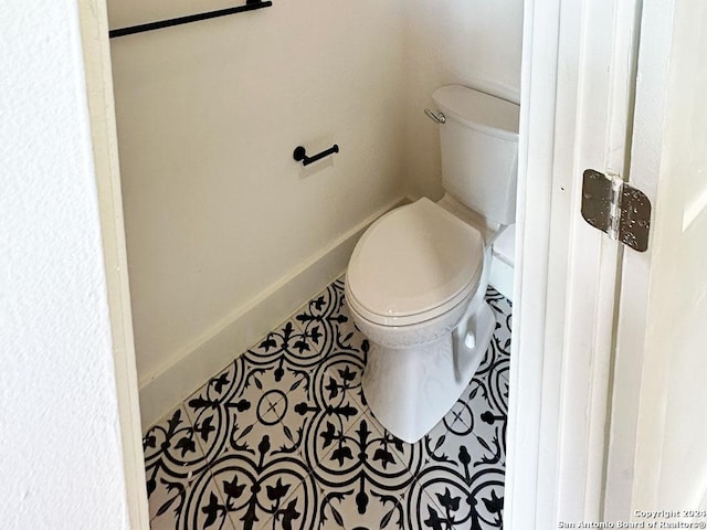 bathroom with tile patterned floors and toilet