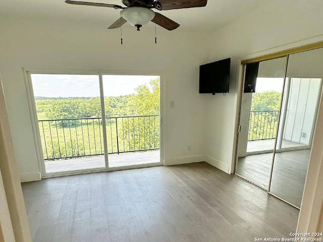 unfurnished room with ceiling fan and light hardwood / wood-style flooring