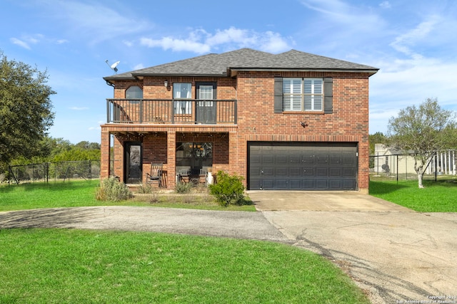 view of front of house with a front yard, a garage, and a balcony