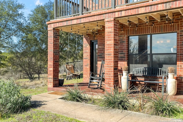 view of patio featuring a balcony