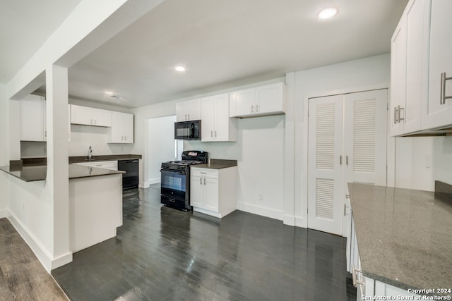 kitchen featuring white cabinetry, dark wood-type flooring, black appliances, kitchen peninsula, and sink