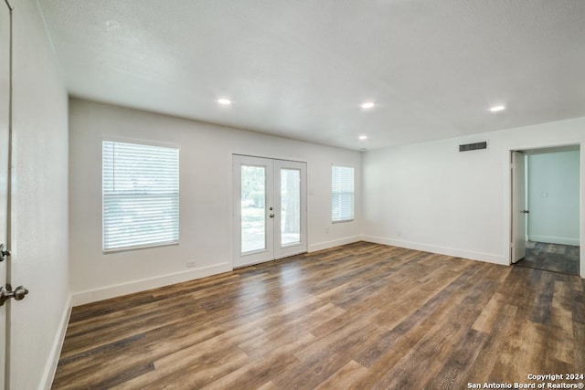 unfurnished room with french doors and dark wood-type flooring