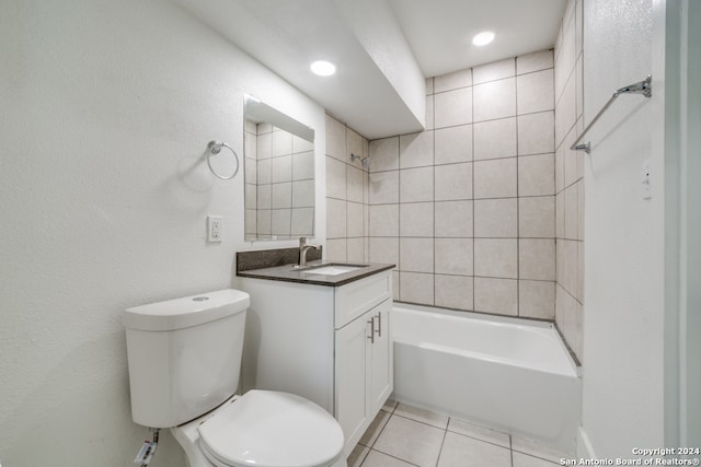 full bathroom with tile floors, tiled shower / bath combo, toilet, and vanity with extensive cabinet space