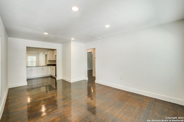 empty room with dark hardwood / wood-style floors