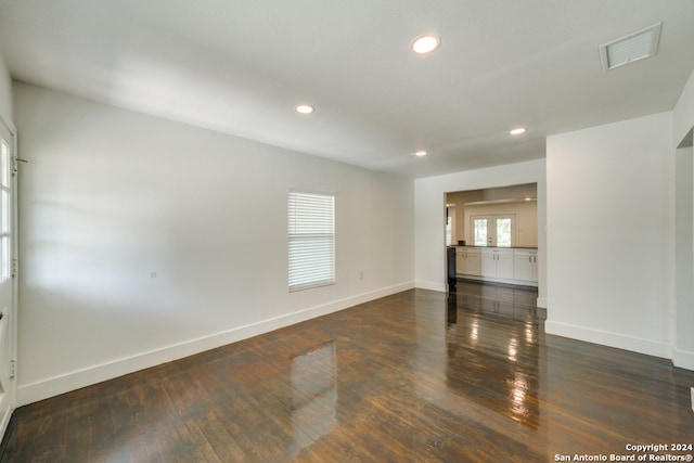 unfurnished room with dark wood-type flooring